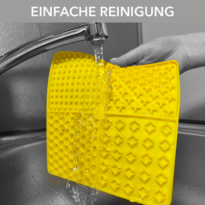 Ein Foto der entoVITAL DOG und CAT Schleckmatte, welches zeigt wie einfach unter fliessendem Wasser des Wasserhahns oder in einer Spülmaschine die Schleckmatte gereinigt werden kann.